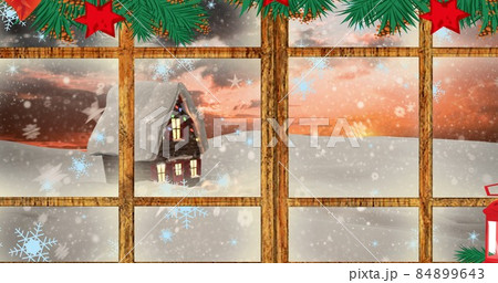Composite image of snow covered house seen through decorated window in christmas, copy space Composite image of snow covered house seen through decorated window in christmas, copy space 84899643