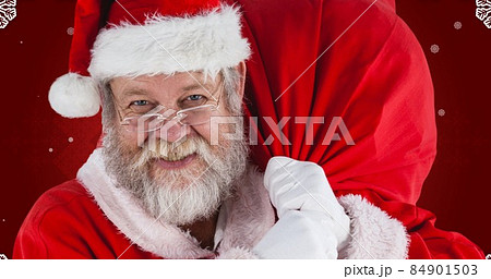 Portrait of happy santa claus carrying bag against maroon background Portrait of happy santa claus carrying bag against maroon background 84901503