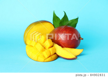 Tasty ripe mango fruit on blue background 84902831