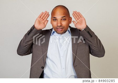 Man African American businessman, holding his hand behind his ear, showing that he does not hear Man African American businessman, holding his hand behind his ear, showing that he does not hear 84903285