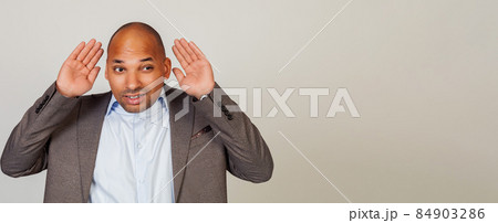 Man African American businessman, holding his hand behind his ear, showing that he does not hear Man African American businessman, holding his hand behind his ear, showing that he does not hear 84903286