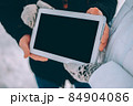 couple demonstration tablet with empty screen. advertising winter theme 84904086