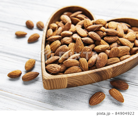 Almonds in brown bowl Almonds in brown bowl 84904922