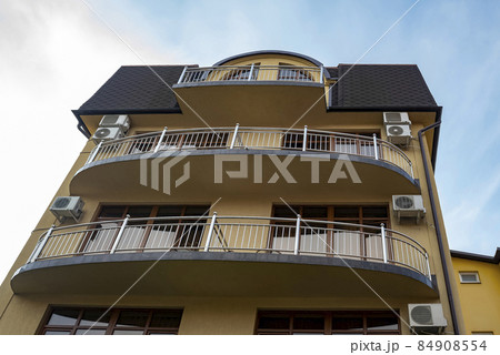 Facade of a hotel building in a summer resort town. Facade of a hotel building in a summer resort town. 84908554