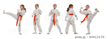 Movements. Sport collage with little girl, young karate in sports uniform posing isolated over white background. Movements. Sport collage with little girl, young karate in sports uniform posing isolated over white background. 84913570