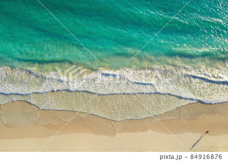 Man run along ocean surf by seascape, top view 84916876