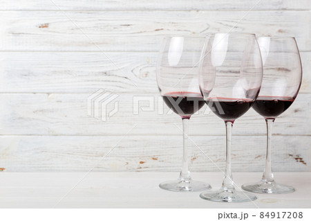 Many glasses of red wine at wine tasting. Concept of red wine on colored background. Top view, flat lay design Many glasses of red wine at wine tasting. Concept of red wine on colored background. Top view, flat lay design 84917208