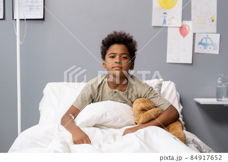 Little boy sitting at hospital bed Little boy sitting at hospital bed 84917652