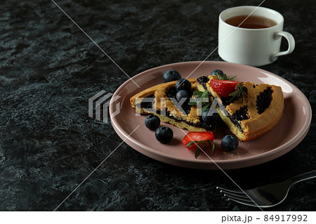 Concept of delicious food with blueberry pie on black smokey background 84917992