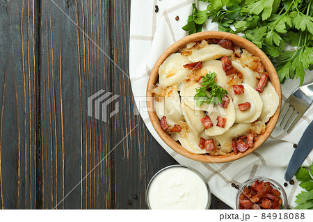 Concept of tasty food with vareniki or pierogi on wooden table 84918088