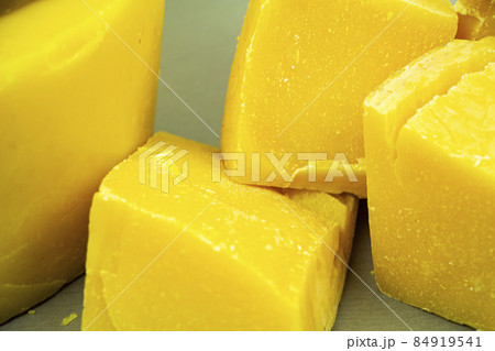 large pieces of natural beeswax, close-up, raw materials for candles. 84919541