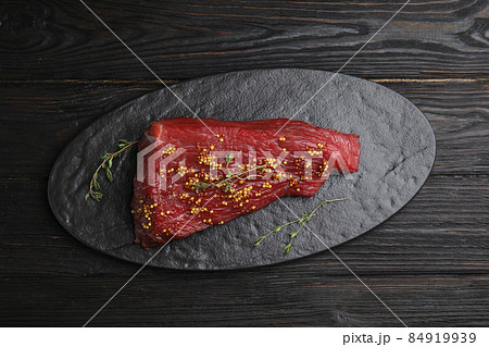 Fresh raw beef cut with thyme and mustard on wooden table, top view Fresh raw beef cut with thyme and mustard on wooden table, top view 84919939