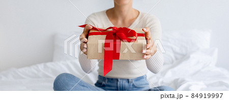 Lady Holding And Giving Wrapped Gift At Home Lady Holding And Giving Wrapped Gift At Home 84919997