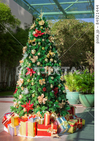 Gift boxes and Christmas trees decorated with colorful ornaments. 84921444