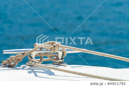 Detail image of yacht rope cleat on sailboat deck. Detail image of yacht rope cleat on sailboat deck. 84921792