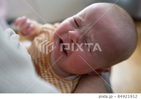Portrait of crying baby girl lying alone on bed. Portrait of crying baby girl lying alone on bed. 84921912