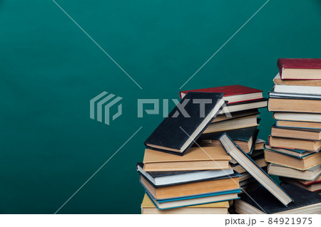 stacks of books for teaching knowledge of the university library green background 84921975