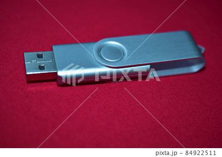 USB flash drive on a red velvet background 84922511