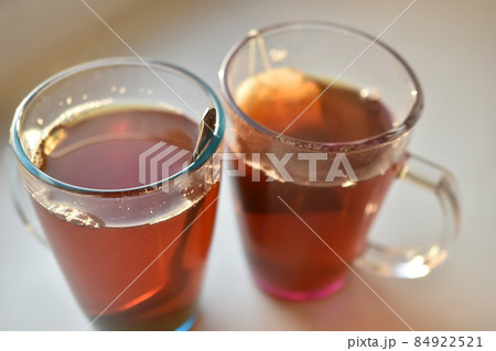 Cup mug of black hot tea with a bag Cup mug of black hot tea with a bag 84922521