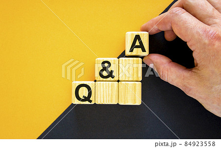 Questions and answers symbol. Concept word 'Q and A, Questions and answers' on cubes on a beautiful yellow background. Businessman hand. Business, Q and A, questions and answers concept. Questions and answers symbol. Concept word 'Q and A, Questions and answers' on cubes on a beautiful yellow background. Businessman hand. Business, Q and A, questions and answers concept. 84923558
