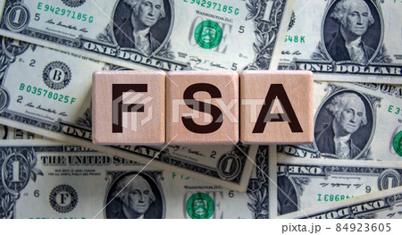 Concept word 'FSA, flexible spending account' on cubes on a beautiful background from dollar bills. Business concept. Copy space. Concept word 'FSA, flexible spending account' on cubes on a beautiful background from dollar bills. Business concept. Copy space. 84923605