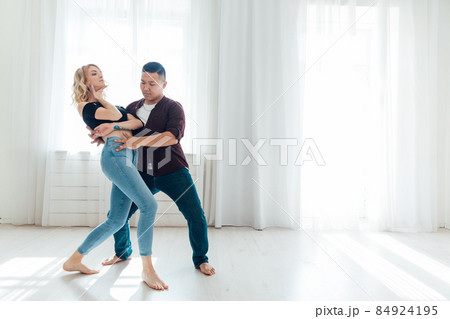 woman and man dancing to bachata music 84924195