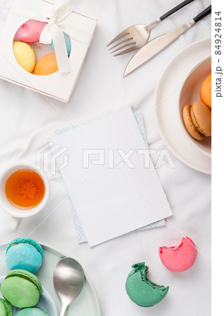 Mockup paper blank and macarons with table setting on textile background 84924814