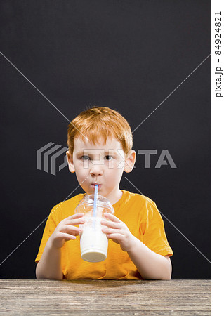 boy at the table drinking a cocktail, boy at the table drinking a cocktail, 84924821