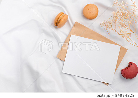 Colorful macarons and mockup letter on white textile 84924828