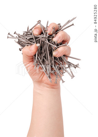 Man's hand holding metal nails (Clipping path) Man's hand holding metal nails (Clipping path) 84925280