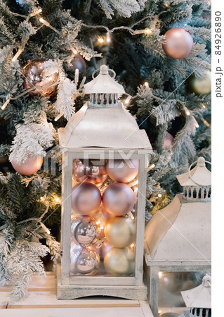 Winter time and lamp on wooden sofa near christmas tree. Cozy vintage holiday home interior Winter time and lamp on wooden sofa near christmas tree. Cozy vintage holiday home interior 84926890