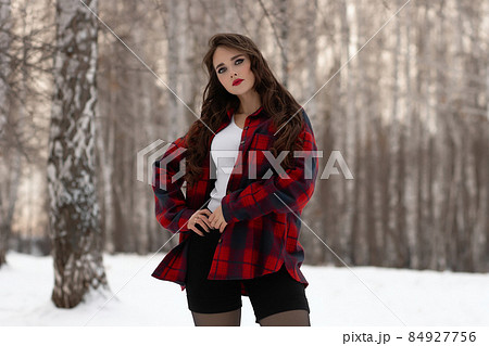Woman with red lips in winter forest 84927756