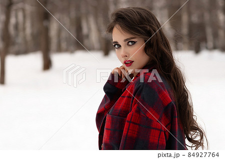 Woman with red lips in winter forest Woman with red lips in winter forest 84927764
