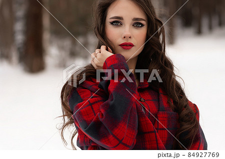 Woman with red lips in winter forest Woman with red lips in winter forest 84927769