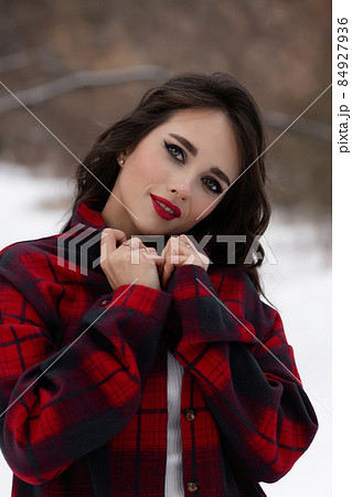 Woman with red lips in winter forest Woman with red lips in winter forest 84927936