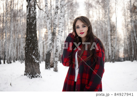 Woman with red lips in winter forest 84927941