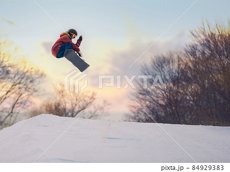 Snowboarder doing an air, all logos removed. 84929383