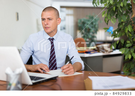 Confident adult man working at office Confident adult man working at office 84929833