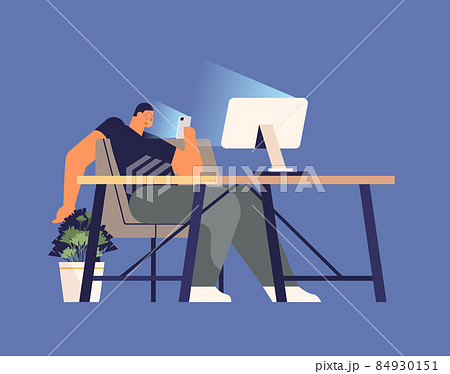 addicted man using digital gadget guy active in social networks at workplace digital addiction concept 84930151