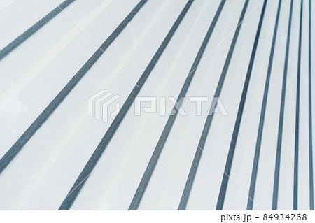 Metal siding with a corrugated pattern of white color diagonally. 84934268