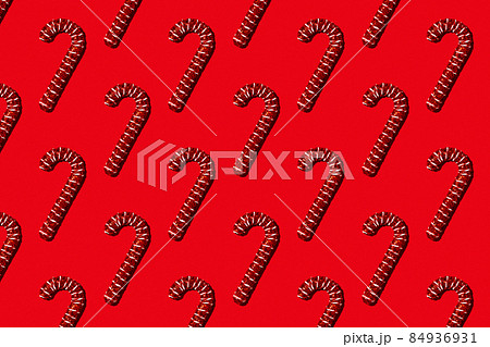 Christmas holiday pattern. Red canes on red background. Christmas holiday pattern. Red canes on red background. 84936931