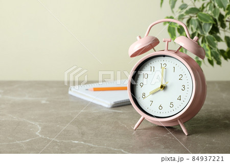 Education concept with alarm clock on gray textured table Education concept with alarm clock on gray textured table 84937221