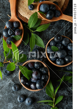 Fresh berry concept with blueberry on black smokey table Fresh berry concept with blueberry on black smokey table 84937519