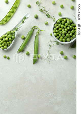 Fresh green pea on white textured background Fresh green pea on white textured background 84937555