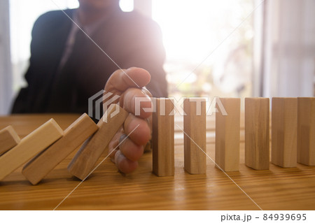 Business man gambling placing wooden block. Business concept  investment target and growth success process background present financial information planning, risk and marketing strategy analysis. 84939695