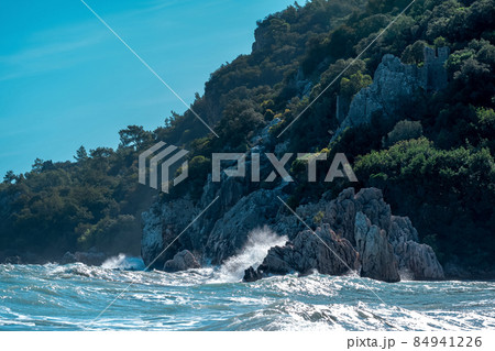 sea surf on a rocky wooded tropical seashore with fortress ruins 84941226