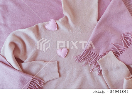 Pair of felt hearts decorate pink cashmere clothes, top view, valentines day concept, warm cozy products  84941345