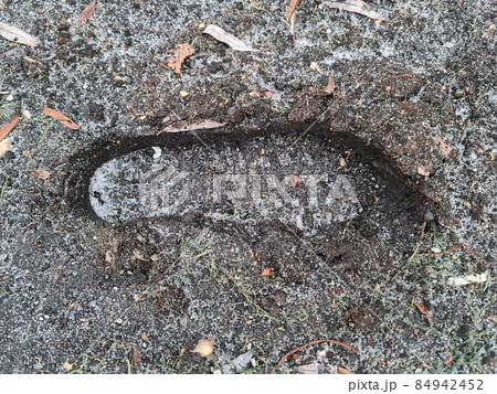 Footprint of men boots in mud winter closeup top view background Footprint of men boots in mud winter closeup top view background 84942452