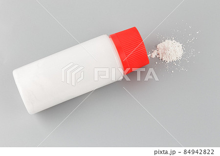 white plastic bottle of baby powder on gray background white plastic bottle of baby powder on gray background 84942822