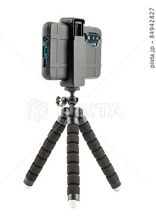 black cellphone in rugged rubber protective cover on small flexible tripod isolated on white black cellphone in rugged rubber protective cover on small flexible tripod isolated on white 84942827